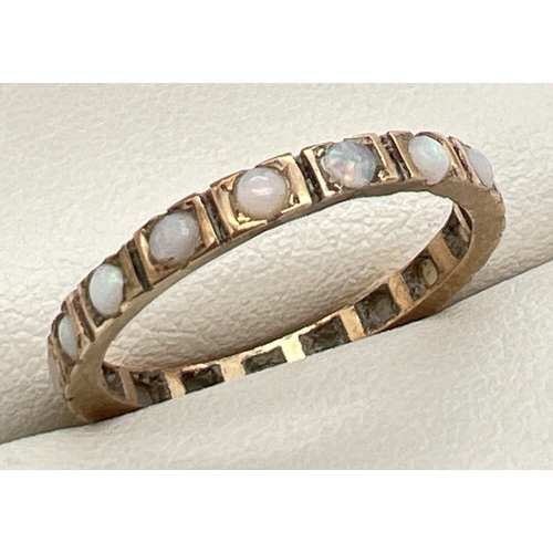 69 - A vintage gold full eternity ring set with 18 small round cut opals. No marks, tests as 9ct gold. Ri... 