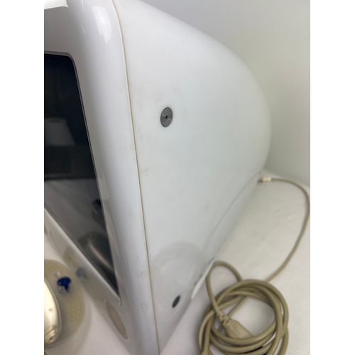 1268 - A 2003 Apple eMac all-in-one desktop computer, model A1002. With keyboard, power cable and Ram acces... 