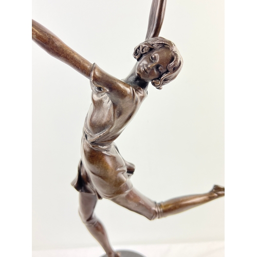 1331 - After Bruno Zach - an Art Deco style bronze figurine of a dancing girl, raised on a conical shaped m... 