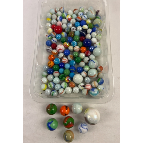 1280 - A collection of vintage Aggie style marbles in various sizes, some with iridescent finish. In both m... 