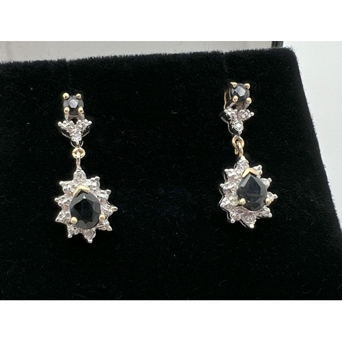 1007 - A pair of 9ct gold sapphire and diamond drop style earrings. Diamond illusion set teardrop cut sapph... 