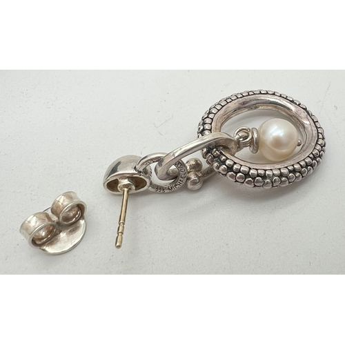 1017 - A pair of silver, 14ct gold and pearl drop earrings by Michael Dawkins. Round white single pearl sus... 