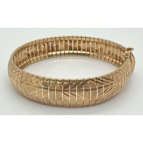 1030 - An Italian gold on silver flexible bracelet with bright cut engraved design to each link. Approx. 8