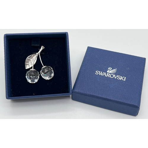 1034 - A boxed Swarovski brooch modelled as cherries with 2 multi faceted clear crystal drops. Stamped with... 