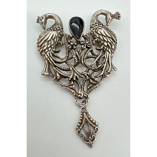 1036 - A large vintage silver pierced work brooch with peacock design, set with teardrop shaped black onyx ... 