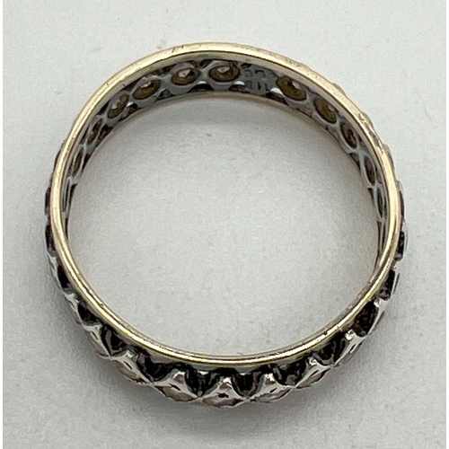 1063 - A 9ct gold and silver full eternity ring set with clear stones in small diamond shaped mounts. Marke... 