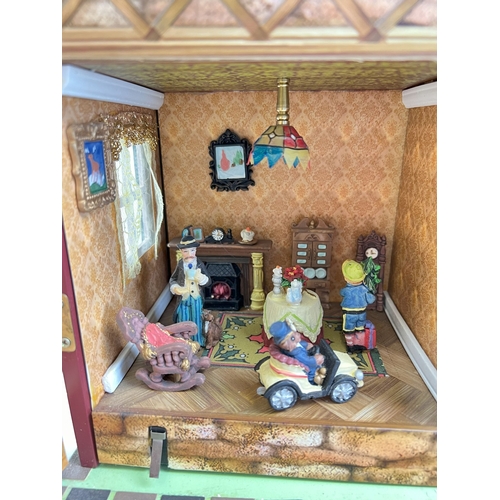 1297 - A Compton & Woodhouse battery operated 'Musical Dolls House' with lights and sounds. Lights up, figu... 