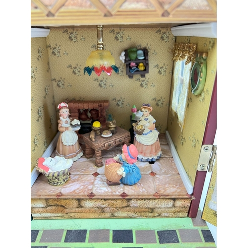 1297 - A Compton & Woodhouse battery operated 'Musical Dolls House' with lights and sounds. Lights up, figu... 