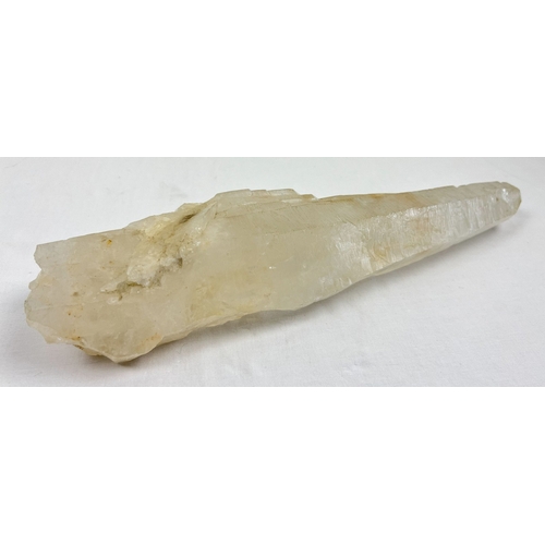 1304 - A large clear quartz natural laser wand with orange, brown and black inclusions. Areas of small clus... 