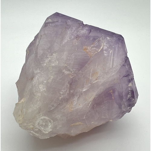 1307 - A large natural amethyst point. Rainbow inclusions visible. Approx. 9cm x 16cm.