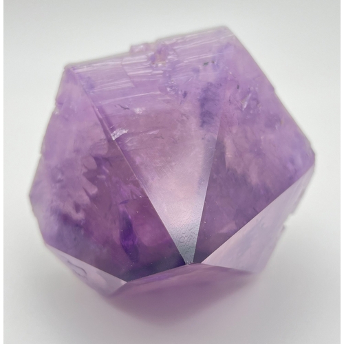 1307 - A large natural amethyst point. Rainbow inclusions visible. Approx. 9cm x 16cm.