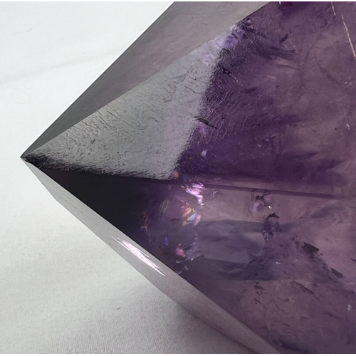 1307 - A large natural amethyst point. Rainbow inclusions visible. Approx. 9cm x 16cm.