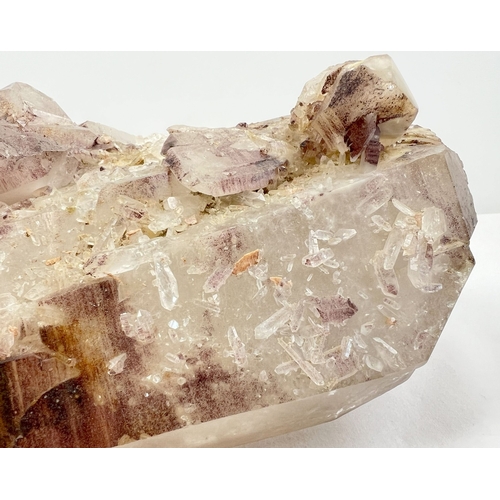 1309 - A large 7.8 kg double terminated smoked quartz crystal point with hematite inclusions and multiple c... 