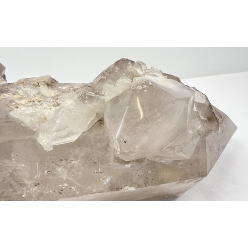 1309 - A large 7.8 kg double terminated smoked quartz crystal point with hematite inclusions and multiple c... 