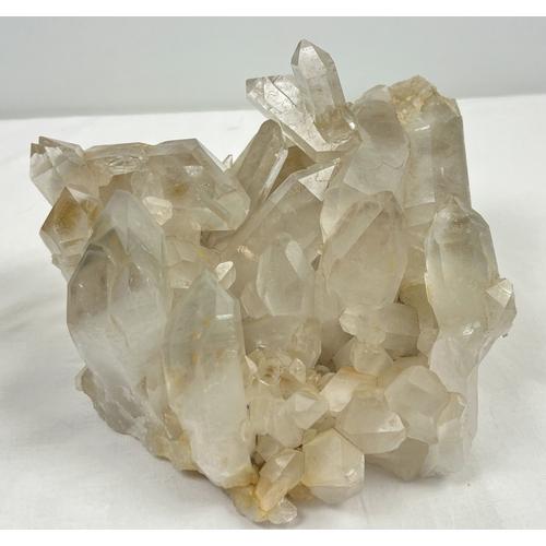 1312 - A large 4.45kg natural clear quartz cluster with natural brown/orange inclusions throughout. Many po... 