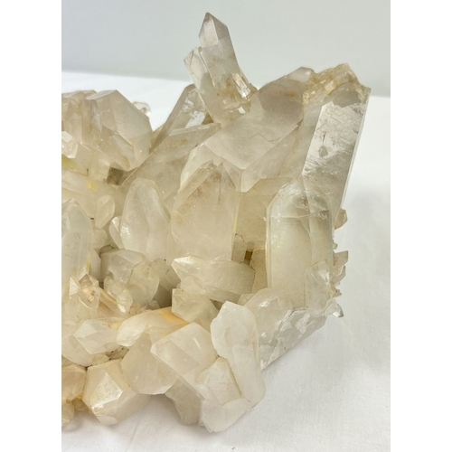 1312 - A large 4.45kg natural clear quartz cluster with natural brown/orange inclusions throughout. Many po... 