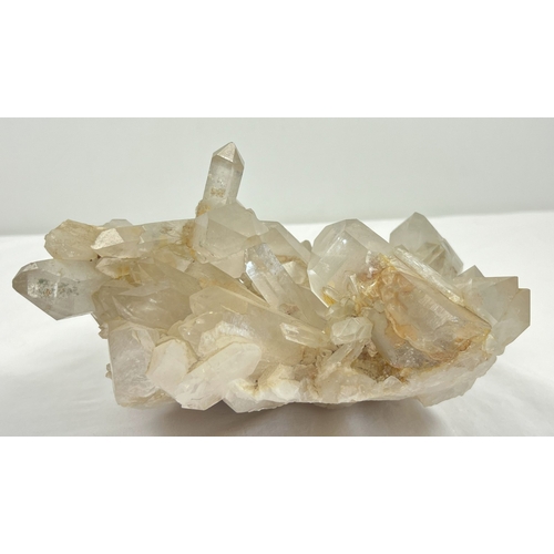 1312 - A large 4.45kg natural clear quartz cluster with natural brown/orange inclusions throughout. Many po... 