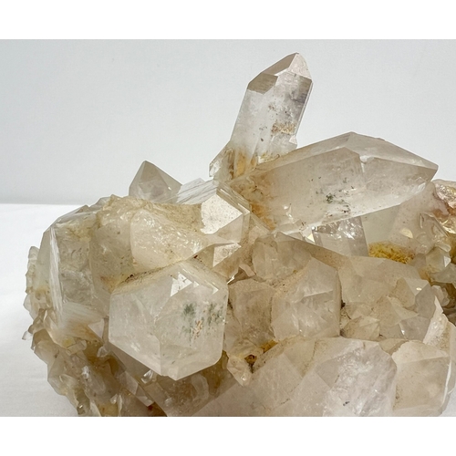 1312 - A large 4.45kg natural clear quartz cluster with natural brown/orange inclusions throughout. Many po... 