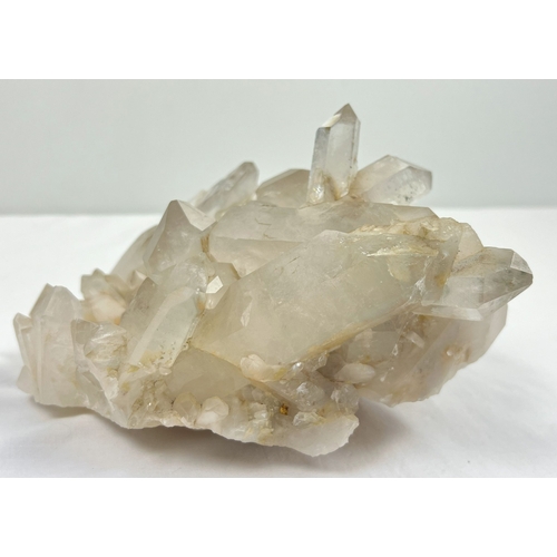 1312 - A large 4.45kg natural clear quartz cluster with natural brown/orange inclusions throughout. Many po... 