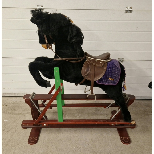 1266 - A vintage rocking horse on a trestle base, with uprights formed as a show jumping fence. With purple... 