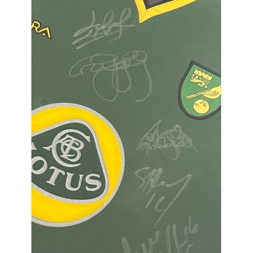 1288 - A framed and glazed signed 2004-05 Norwich City Football Club Xara training shirt with Lotus sponsor... 