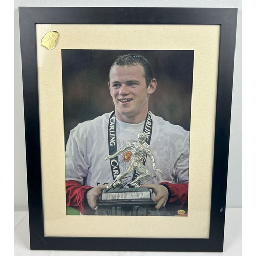 1290 - A framed and glazed signed photograph of Manchester United footballer Wayne Rooney. Complete with ce... 