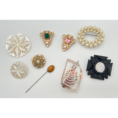 1153 - A collection of assorted vintage brooches and dress clips to include carved mother of pearl, lucite,... 