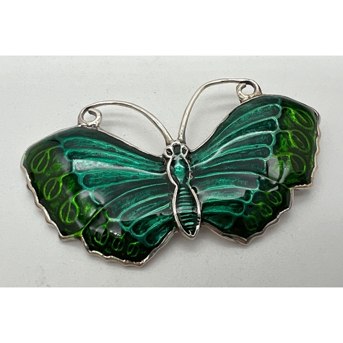 1155 - A green enamelled silver butterfly brooch, stamped sterling to reverse. Approx. 5.5cm wide.