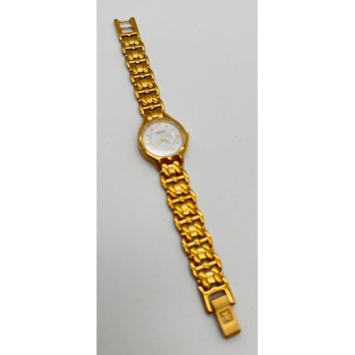 1179 - A ladies gold tone stainless steel strap wristwatch by Tissot. White face with gold tone hour marker... 