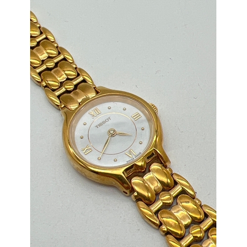 1179 - A ladies gold tone stainless steel strap wristwatch by Tissot. White face with gold tone hour marker... 