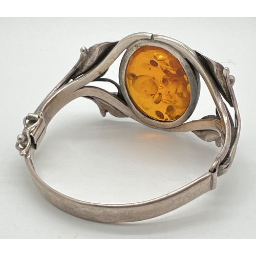 1001 - A large Art Nouveau style silver bracelet with decorative Lily design mount, set with a large oval a... 