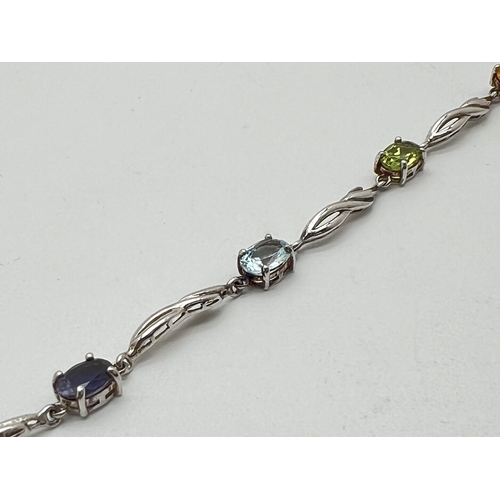 1017 - A silver and gemstone set bracelet with lobster claw clasp. Alternating twist design links and oval ... 