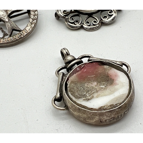 1018 - 3 items of vintage silver jewellery. A circular brooch with bird decoration and name Hethersett, com... 