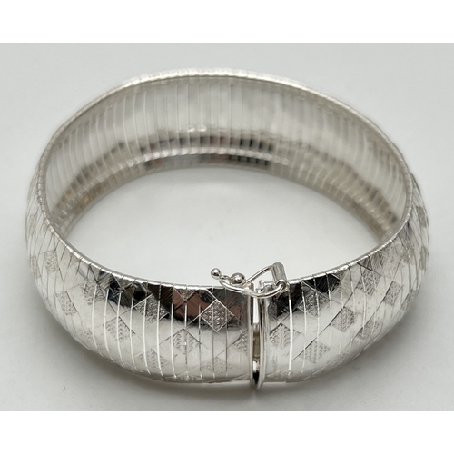 1020 - A sterling silver Cleopatra bracelet with diamond pattern throughout. Push clasp with safety clip. S... 