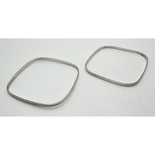 1028 - 2 thin square shaped bangles. Silver marks to inside, approx 2mm wide. Approx. 7cm corner to corner.