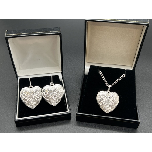 1032 - A modern silver heart shaped pendant with embossed floral design, with matching drop style earrings ... 