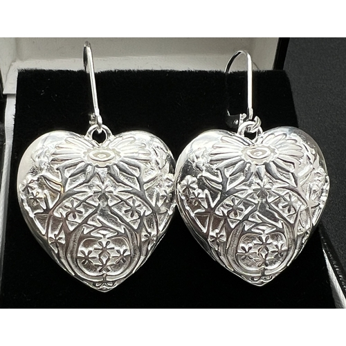 1032 - A modern silver heart shaped pendant with embossed floral design, with matching drop style earrings ... 