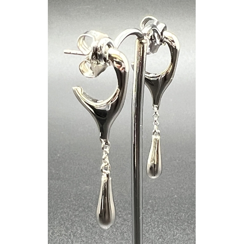 1037 - A pair of silver modern design drop style earrings with butterfly backs. Half huggie style hoop with... 