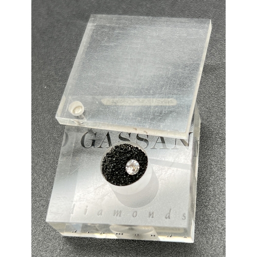 1051 - A 0.10ct round cut diamond by Gassan. In swivel top clear perspex presentation case and original box... 