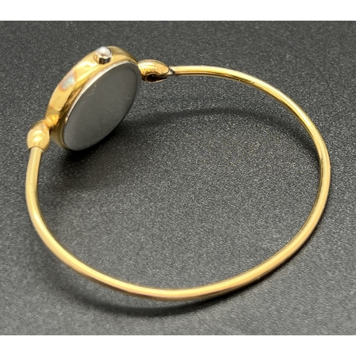 1166 - A ladies gold plated bangle quartz wristwatch by Michael Heberlin, Paris. Brushed gold face set with... 