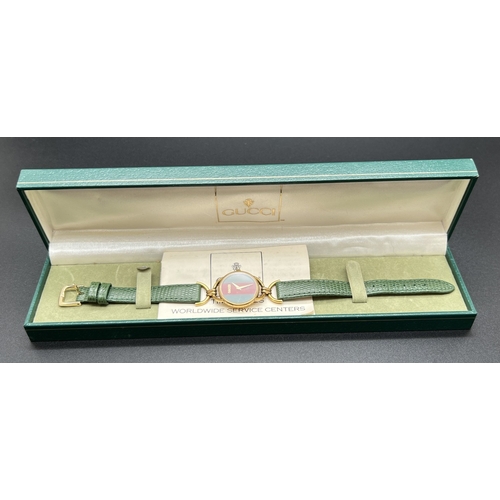 1168 - A vintage horse bit wristwatch by Gucci, 6000L. Classic green and red stripe detail to face with gol... 