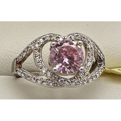 1052 - A rhodium plated cocktail ring set with Swarovski crystals, new with tag. A central pale pink round ... 