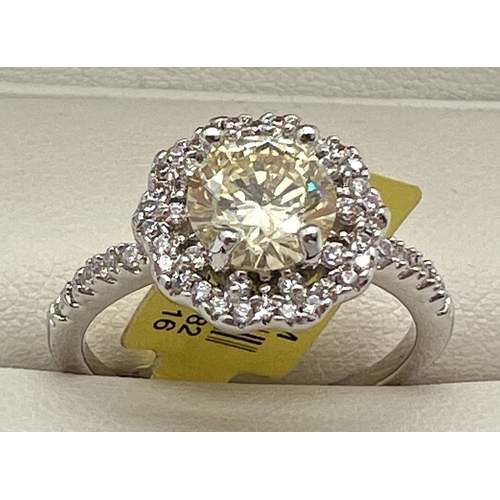 1053 - A rhodium plated cocktail ring set with Swarovski crystals, new with tag. Central round cut lemon st... 
