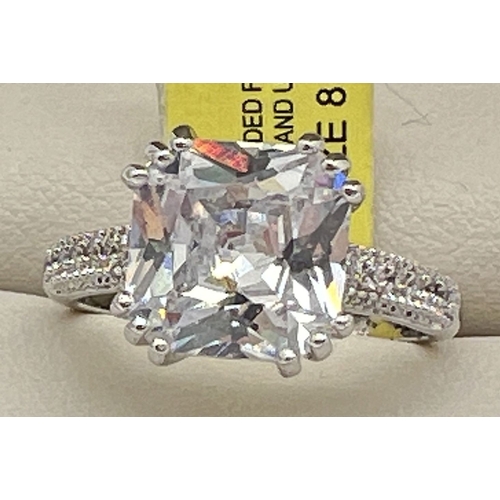 1054 - A rhodium plated Art Deco style cocktail ring set with Swarovski crystals, new with tag. Central squ... 