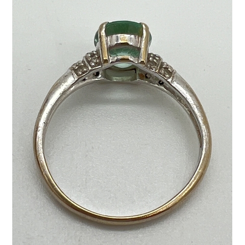 1061 - An 18ct gold green amethyst and diamond ring with central oval cut green amethyst and 2 rows of smal... 