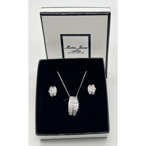 1067 - A boxed set of stud style earrings and matching necklace by Martin James, London. Both earrings and ... 