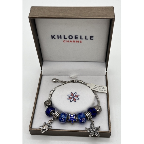 1078 - A costume jewellery charm bracelet by Khloelle Charms, new in original box with tags. Lobster claw c... 