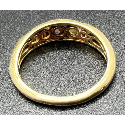 1086 - A large gold on silver multi gem set dress ring, stamped 925 inside band, ring size V½. Band set wit... 