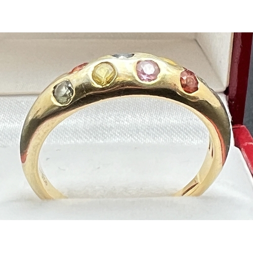 1086 - A large gold on silver multi gem set dress ring, stamped 925 inside band, ring size V½. Band set wit... 