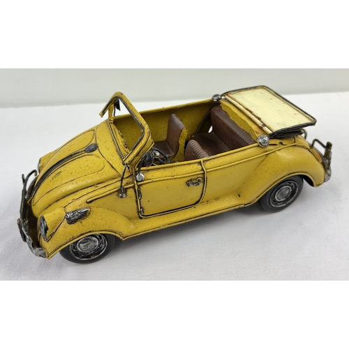 1195 - A tin plate metal model of a yellow Volkswagen convertible car. Approx. 34cm long.